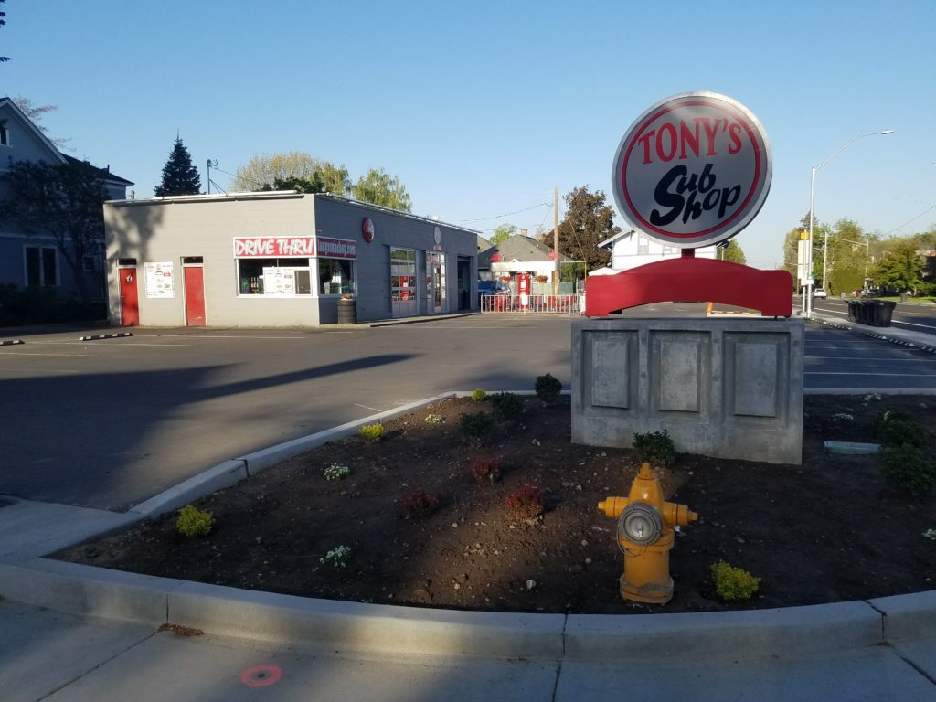 Corner of Tony's Sub Shop with its pole sign on E Isaacs Ave