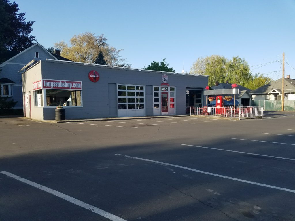 Tony's Sub Shop on E Isaacs Ave, a converted mid-century gas station with a red vintage gas pump on the patio